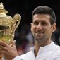 Serbia&#39;s Novak Djokovic holds the winners trophy as he poses for photographers after he defeated Italy&#39;s Matteo Berrettini in the men&#39;s singles final on day thirteen of the Wimbledon Tennis Championships in London, Sunday, July 11, 2021. Novak Djokovic will be allowed to defend his title at Wimbledon, despite not being vaccinated against COVID-19, because the shots are not required to enter Britain, All England Club chief executive Sally Bolton said Tuesday, April 26, 2022. (AP Photo/Kirsty Wigglesworth, File) **FILE**