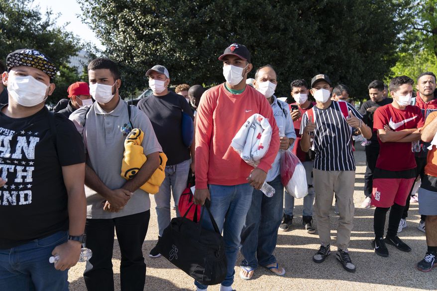 Migrants hold Red Cross blankets after arriving at Union Station near the U.S. Capitol from Texas on buses, Wednesday, April 27, 2022, in Washington. Texas Gov. Greg Abbott has said the state will provide migrants arriving at the U.S.-Mexico border bus charters to Washington. (AP Photo/Jose Luis Magana) ** FILE **