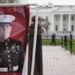 A poster photo of U.S. Marine Corps veteran and Russian prisoner Trevor Reed stands in Lafayette Park near the White House, March 30, 2022, in Washington. (AP Photo/Patrick Semansky, File)