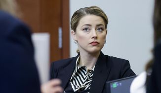 Actor Amber Heard appears in the courtroom at the Fairfax County Circuit Court in Fairfax, Va., Wednesday, April 27, 2022. Actor Johnny Depp sued his ex-wife actress Amber Heard for libel in Fairfax County Circuit Court after she wrote an op-ed piece in The Washington Post in 2018 referring to herself as a &amp;quot;public figure representing domestic abuse.&amp;quot; (Jonathan Ernst/Pool Photo via AP)