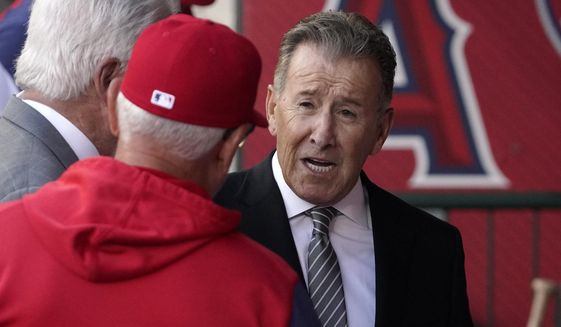 Los Angeles Angels owner Arte Moreno, right, talks with Angels manager Joe Maddon prior to a baseball game against the Cleveland Guardians Tuesday, April 26, 2022, in Anaheim, Calif. (AP Photo/Mark J. Terrill)