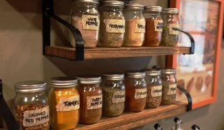 This image shows an heirloom spice rack made with mason jars in a kitchen in Allison Park, Pa. When you live in a multigenerational house, deep-time design opportunities lurk around every corner. Opportunities to blend past and present abound. (AP Photo/Ted Anthony)