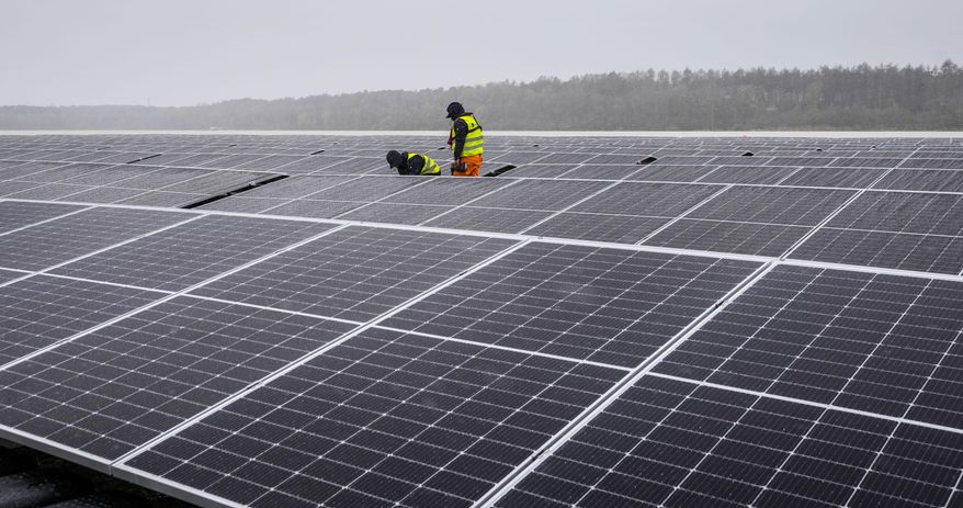 Solar panels are installed at a floating photovoltaic plant on a lake in Haltern, Germany, on April 1, 2022. (AP Photo/Martin Meissner) ** FILE **