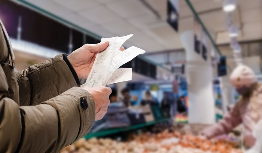 Man checks receipts. File photo credit Denys Kurbatov via Shutterstock.