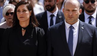 Israeli Prime Minister Naftali Bennett and his wife Gilat take part in the ceremony marking Holocaust Remembrance Day at Warsaw Ghetto Square at the Yad Vashem memorial in Jerusalem, Thursday, April 28, 2022. (Amir Cohen/Pool Photo via AP)