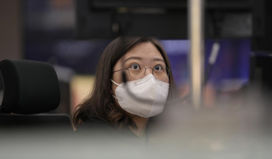 A currency trader watches computer monitors at a foreign exchange dealing room in Seoul, South Korea, Thursday, April 28, 2022. (AP Photo/Lee Jin-man)