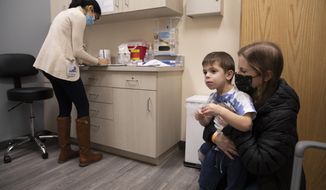 Ilana Diener holds her son, Hudson, 3, during an appointment for a Moderna COVID-19 vaccine trial in Commack, N.Y. on Nov. 30, 2021. The FDA said it set aside meeting dates on June  8, 21, and 22 to discuss vaccines for young children with the Vaccines and Related Biological Products Advisory Committee (VRBPAC) as it waits for final submissions from Moderna and Pfizer. (AP Photo/Emma H. Tobin, File)  **FILE**