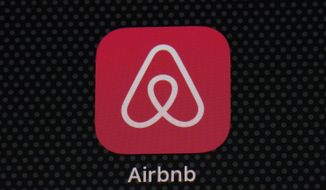 FILE - The Airbnb app icon is seen on an iPad screen, Saturday, May 8, 2021, in Washington.  Airbnb will allow its employees to live and work almost anywhere around the world, fully embracing a remote work policy to attract staff and ensure flexibility.  The San Francisco short-term-stay company said late Thursday, April 28, 2022,  that under the new policy, employees can work from the office, home or during their travels to 190 countries. (AP Photo/Patrick Semansky, File)