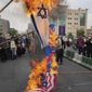 Demonstrators burn representations of Israeli, British and U.S. flags during the annual pro-Palestinians Al-Quds, or Jerusalem, Day rally in Tehran, Iran, Friday, April 29, 2022. Iran does not recognize Israel and supports Hamas and Hezbollah, militant groups that oppose it. (AP Photo/Vahid Salemi)