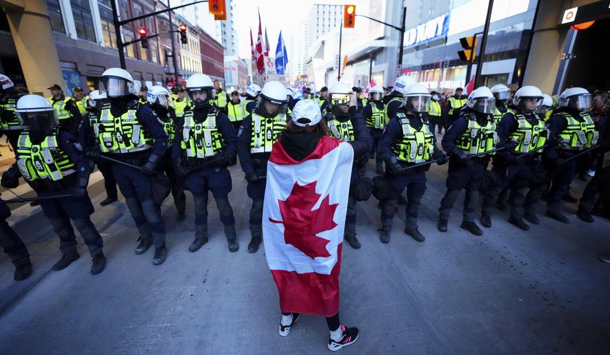 A protester confronts police during a demonstration, part of a convoy-style protest participants are calling &amp;quot;Rolling Thunder&amp;quot;, Friday, April 29, 2022, in Ottawa. (Sean Kilpatrick/The Canadian Press via AP)