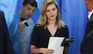 FILE - Ukrainian President Volodymyr Zelenskyy, left, and his wife Olena Zelenska leave a booth at a polling station during a parliamentary election in Kiev, Ukraine, Sunday, July 21, 2019. Ukraine&#39;s first lady, Olena Zelenska, says that the war has not changed her husband, but only revealed his qualities, including a determination to prevail, to the world. Zelenska, speaking in an interview with the Polish newspaper Rzeczpospolita published Friday, April 29, 2022, also says she has not seen her husband since Russia invaded Ukraine on Feb. 24.  (AP Photo/Evgeniy Maloletka, File)
