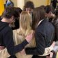 Mariia Pachenko, top center, huddles with Ukrainian peers in prayer on April 8, 2022, as the group disbands after spending nearly a week together taking part in the National Model United Nations Conference in New York. (AP Photo/Bobby Caina Calvan)