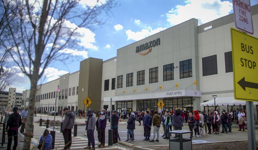In this image from video, Amazon workers line up outside the company&#x27;s Staten Island warehouse to vote on unionization, Friday, March 25, 2022, in New York. Amazon and the nascent group that successfully organized the company’s first-ever U.S. union are headed for a rematch Monday, May 2, 2022, when a federal labor board will tally votes cast by warehouse workers in yet another election on Staten Island. (AP Photo/Robert Bumsted) **FILE**