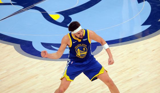 Golden State Warriors&#39; Klay Thompson (11) celebrates his 3-point basket against the Memphis Grizzlies in the second half of Game 1 of a second-round NBA basketball playoff series in Memphis, Tenn., Sunday, May 1, 2022. (Carlos Avila Gonzalez/San Francisco Chronicle via AP)