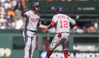 Washington Nationals&#39; Yadiel Hernandez, left, is congratulated by first base coach Eric Young Jr. (12) after hitting a three-run double against the San Francisco Giants during the eighth inning of a baseball game in San Francisco, Sunday, May 1, 2022. (AP Photo/Jeff Chiu)