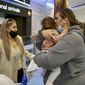 Families embrace after a flight from Los Angeles arrived at Auckland International Airport as New Zealand&#39;s border opened for visa-waiver countries Monday, May 2, 2022. New Zealand welcomed tourists from the U.S., Canada, Britain, Japan and more than 50 other countries for the first time in more than two years as it dropped most of its remaining pandemic border restrictions. (Jed Bradley/New Zealand Herald via AP)