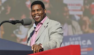 Herschel Walker, front-runner for the party&#39;s U.S. Senate nominee, speaks during a rally for Georgia GOP candidates at Banks County Dragway in Commerce, Ga., Saturday, March 26, 2022. In his run for U.S. Senate in Georgia, former football great Herschel Walker has gone to great lengths so far to dodge tough questions. The GOP candidate does not widely publicize his campaign stops and limits his appearances mostly to conservative news outlets and friendly audiences. Earlier this month, he skipped the first debate for the May 24 Republican primary. (Hyosub Shin/Atlanta Journal-Constitution via AP, File)