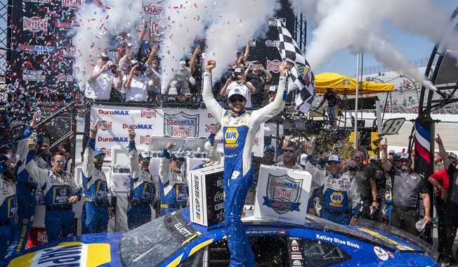 Chase Elliott, center, celebrates in Victory Lane after a NASCAR Cup Series auto race at Dover Motor Speedway, Monday, May 2, 2022, in Dover, Del. (AP Photo/Jason Minto)