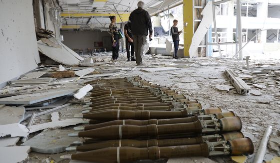 RPG shells lie in the hall of a destroyed school in Mariupol, in territory under the government of the Donetsk People&#39;s Republic, eastern Ukraine, Monday, May 2, 2022. (AP Photo/Alexei Alexandrov)