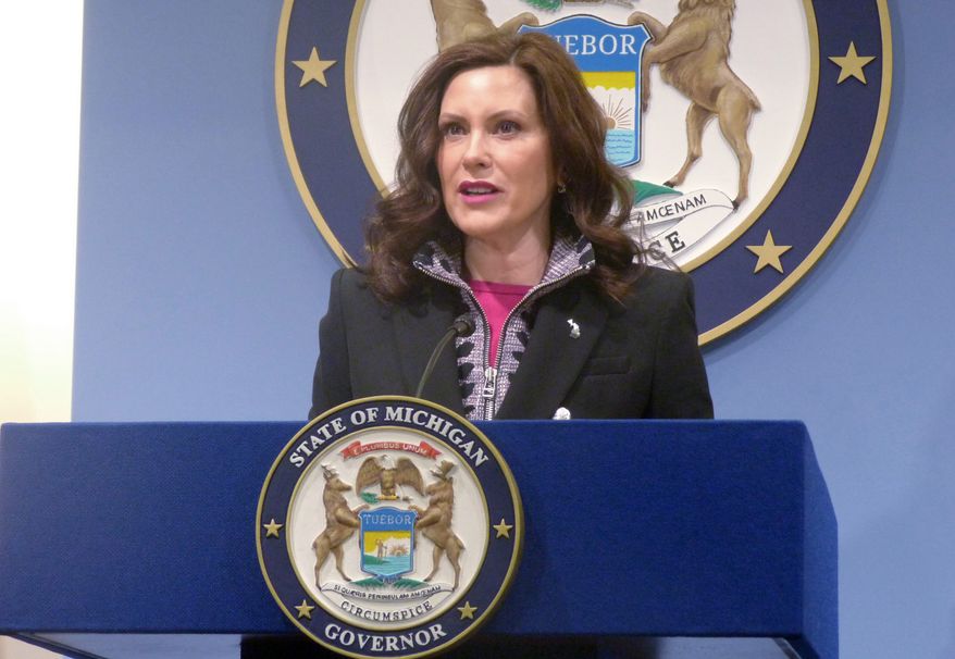 Michigan Gov. Gretchen Whitmer speaks at a news conference on Friday, March 11, 2022, at the governor's office in Lansing, Mich. Whitmer vetoed legislation that would have required voter registration applications to include a statement that the applicant understands it is a felony to try to vote more than once in the same election. Her office announced the veto Friday, April 29, 2022, saying the bill was part of a larger package of election measures that was not negotiated and aims "to restrict or chill access to the ballot." (AP Photo/David Eggert, File)