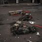 The bodies of unidentified men, believed to be Russian soldiers, arranged in a Z, a symbol of the Russian invasion, lie near a village recently retaken by Ukrainian forces on the outskirts of Kharkiv, Ukraine, Monday, May 2, 2022. The outskirts of Kharkiv have the feel of an open-air morgue, where the dead lie unclaimed and unexplained, sometimes for weeks on end, as Ukrainian and Russian forces fight for control of slivers of land. (AP Photo/Felipe Dana)