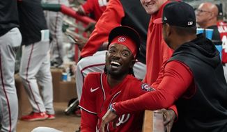 Washington Nationals second baseman Dee Strange-Gordon, left, laughs with manager Dave Martinez after pitching in relief during the eighth inning of the team&#39;s baseball game against the Atlanta Braves on Tuesday, April 12, 2022, in Atlanta. The Braves won 16-4. (AP Photo/John Bazemore) **FILE **