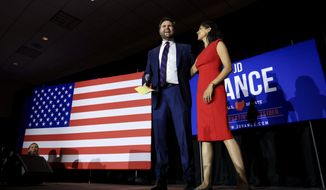 Republican Senate candidate J.D. Vance, left, stands on stage with his wife Usha Vance during an election night watch party, Tuesday, May 3, 2022, in Cincinnati. (AP Photo/Aaron Doster)