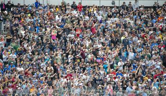 Fans in the stands at the NASCAR Cup Series auto race at Dover Motor Speedway, Sunday, May 1, 2022, in Dover, Del. (AP Photo/Jason Minto) **FILE**