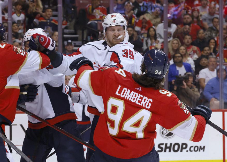 Washington Capitals right wing Anthony Mantha (39) shoves Florida Panthers left wing Ryan Lomberg (94) during the second period of Game 1 of an NHL hockey first-round playoff series Tuesday, May 3, 2022, in Sunrise, Fla. (AP Photo/Reinhold Matay)