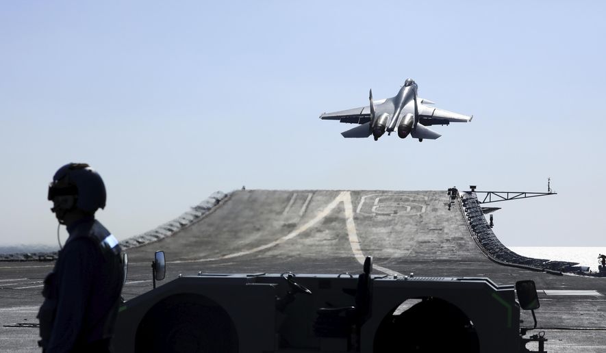In this undated photo released on Dec. 31. 2021, by Xinhua News Agency, a carrier-based J-15 fighter jet takes off from the Chinese Navy&#x27;s Liaoning aircraft-carrier during open-sea combat training in waters from the Yellow Sea to the East Sea and West Pacific. China&#x27;s Liaoning aircraft carrier group has embarked on a &amp;quot;realistic combat&amp;quot; training mission in the Western Pacific, the Chinese navy said Tuesday, May 3, 2022. (Hu Shanmin/Xinhua via AP)