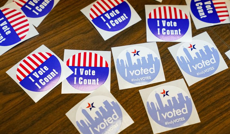 Stickers await voters during primary election voting in Indianapolis, Tuesday, May 3, 2022. (AP Photo/Michael Conroy)