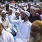 A man captures video as Muslims offer Eid al-Fitr prayers in Gauhati, India, Tuesday, May 3, 2022. Eid al-Fitr marks the end of the fasting month of Ramadan. (AP Photo/Anupam Nath)