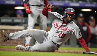 Washington Nationals&#39; Josh Bell scores on a single by Keibert Ruiz off Colorado Rockies relief pitcher Justin Lawrence in the ninth inning of a baseball game Tuesday, May 3, 2022, in Denver. (AP Photo/David Zalubowski)