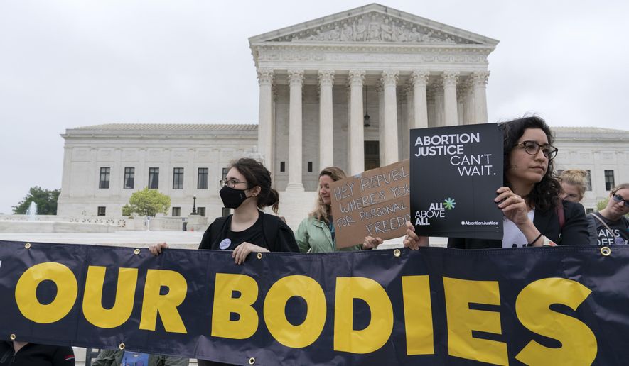 Demonstrators protest outside of the U.S. Supreme Court Tuesday, May 3, 2022 in Washington. A draft opinion suggests the U.S. Supreme Court could be poised to overturn the landmark 1973 Roe v. Wade case that legalized abortion nationwide, according to a Politico report released Monday. Whatever the outcome, the Politico report represents an extremely rare breach of the court's secretive deliberation process, and on a case of surpassing importance. (AP Photo/Jose Luis Magana)