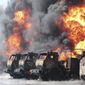Vehicles are on fire at an oil depot after missiles struck the facility in an area controlled by Russian-backed separatist forces in Makiivka, 15 km (94 miles) east of Donetsk, eastern Ukraine, Wednesday, May 4, 2022. (AP Photo)