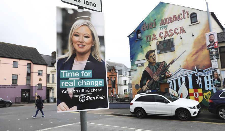 A Sinn Fein election poster hangs from a lamp post in West Belfast, Northern Ireland, Tuesday, May 3, 2022. Sinn Fein, a force in Irish republicanism on both sides of the Irish border looks likely to become the largest party in the assembly, according to polls ahead of the May 5, 2022 local elections. (AP Photo/Peter Morrison)