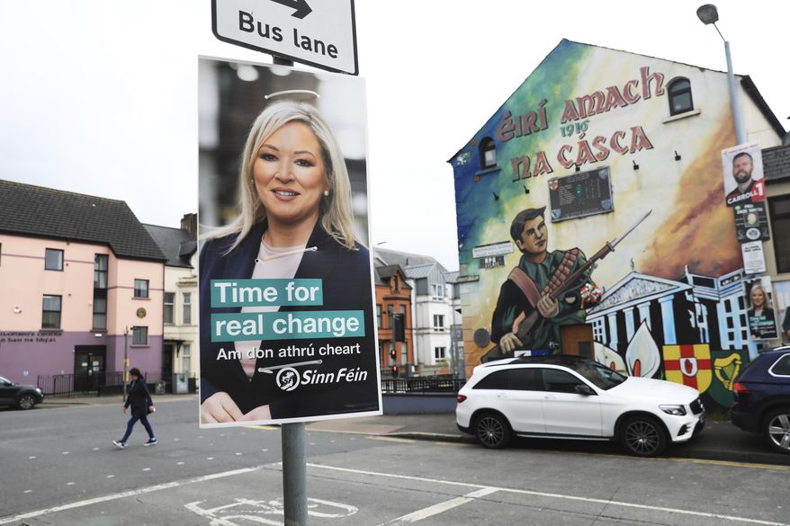 A Sinn Fein election poster hangs from a lamp post in West Belfast, Northern Ireland, Tuesday, May 3, 2022. Sinn Fein, a force in Irish republicanism on both sides of the Irish border looks likely to become the largest party in the assembly, according to polls ahead of the May 5, 2022 local elections. (AP Photo/Peter Morrison)