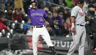 Colorado Rockies&#39; Connor Joe gestures to the dugout after reaching third base with a triple that brought in two runs in the fourth inning of a baseball game against the Washington Nationals, Wednesday, May 4, 2022, in Denver. (AP Photo/David Zalubowski)