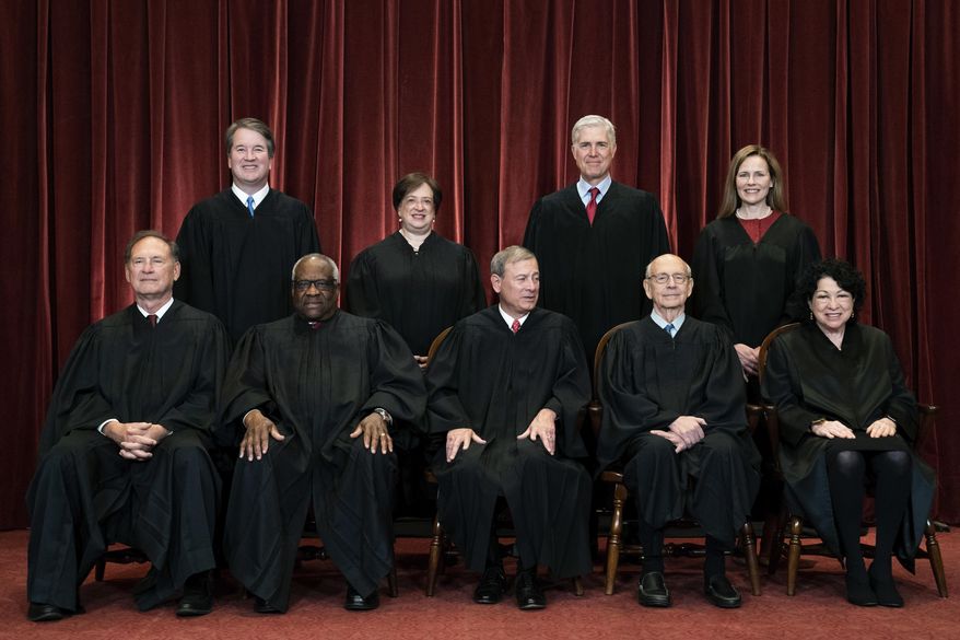 In this April 23, 2021, file photo, members of the Supreme Court pose for a group photo at the Supreme Court in Washington. Seated from left are Associate Justice Samuel A. Alito Jr., Associate Justice Clarence Thomas, Chief Justice John G. Roberts Jr., Associate Justice Stephen G. Breyer and Associate Justice Sonia Sotomayor, while standing from left are Associate Justice Brett M. Kavanaugh, Associate Justice Elena Kagan, Associate Justice Neil M. Gorsuch and Associate Justice Amy Coney Barrett. (Erin Schaff/The New York Times via AP, Pool)