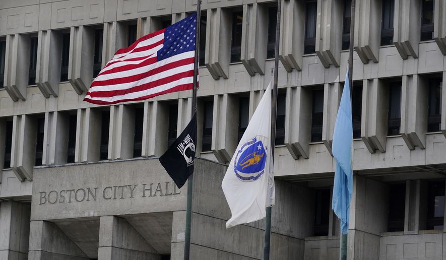 The American flag, the Commonwealth of Massachusetts flag, and the City of Boston flag, from left, fly outside Boston City Hall, Monday, May 2, 2022, in Boston. A unanimous Supreme Court has ruled that Boston violated the free speech rights of a conservative activist when it refused his request to fly a Christian flag on a flagpole outside City Hall. Justice Stephen Breyer wrote for the court Monday that the city discriminated against the activist because of his &quot;religious viewpoint,&quot; even though it had routinely approved applications for the use of one of the three flagpoles outside City Hall that fly the U.S., Massachusetts and Boston flags. (AP Photo/Charles Krupa)