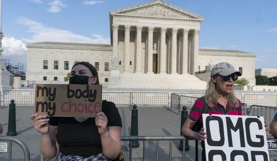 Demonstrators protest outside of the U.S. Supreme Court Wednesday, May 4, 2022 in Washington. (AP Photo/Alex Brandon)