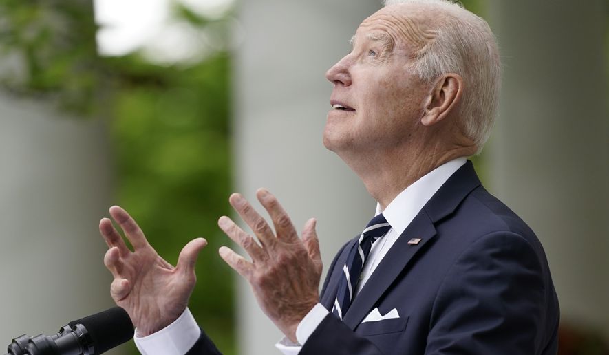 President Joe Biden looks to the sky as he speaks about the forecasted rain during a Cinco de Mayo event in the Rose Garden of the White House, Thursday, May 5, 2022, in Washington. First lady Jill Biden stands at right. (AP Photo/Evan Vucci)