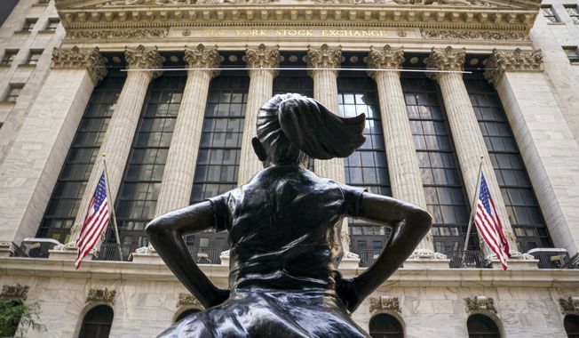 In this Aug. 25, 2020, file photo, the &#x27;Fearless Girl&#x27; bronze sculpture, commissioned by State Street Global Advisors, looks towards the New York Stock Exchange from its roadside perch in New York. Amid the push to get U.S. boardrooms to look more like companies’ customers and employees, advocates are finally seeing just how steep the task will be. Boards of directors at publicly traded U.S. companies are much more white and much less diverse than the overall population, often starkly so. (AP Photo/Bebeto Matthews, File)