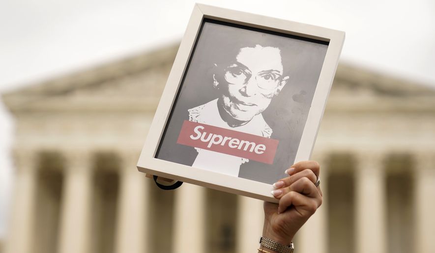 A protester holds up an image of late Supreme Court Justice Ruth Bader Ginsburg outside of the U.S. Supreme Court, Thursday, May 5, 2022, during a demonstration in Washington. A draft opinion suggests the U.S. Supreme Court could be poised to overturn the landmark 1973 Roe v. Wade case that legalized abortion nationwide, according to a Politico report released Monday. Whatever the outcome, the Politico report represents an extremely rare breach of the court&#39;s secretive deliberation process, and on a case of surpassing importance. (AP Photo/Mariam Zuhaib)