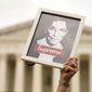 A protester holds up an image of late Supreme Court Justice Ruth Bader Ginsburg outside of the U.S. Supreme Court, Thursday, May 5, 2022, during a demonstration in Washington. A draft opinion suggests the U.S. Supreme Court could be poised to overturn the landmark 1973 Roe v. Wade case that legalized abortion nationwide, according to a Politico report released Monday. Whatever the outcome, the Politico report represents an extremely rare breach of the court&#39;s secretive deliberation process, and on a case of surpassing importance. (AP Photo/Mariam Zuhaib)
