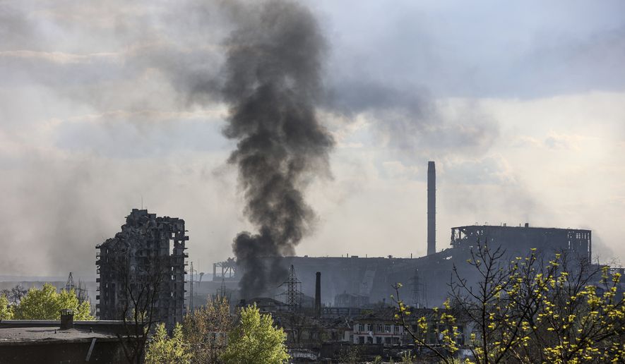 Smoke rises from the Metallurgical Combine Azovstal in Mariupol, in territory under the government of the Donetsk People&#39;s Republic, eastern Ukraine, Wednesday, May 4, 2022. (AP Photo/Alexei Alexandrov)