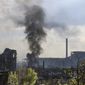 Smoke rises from the Metallurgical Combine Azovstal in Mariupol, in territory under the government of the Donetsk People&#39;s Republic, eastern Ukraine, Wednesday, May 4, 2022. (AP Photo/Alexei Alexandrov)