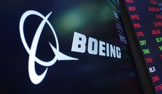 In this July 13, 2021, photo, the logo for Boeing appears on a screen above a trading post on the floor of the New York Stock Exchange. Boeing Co., a leading defense contractor and one of the world&#39;s two dominant manufacturers of airline planes, is expected to move its headquarters from Chicago to the Washington, D.C., area, according to two people familiar with the matter. The decision could be announced as soon as later Thursday, May 5, 2022, according to one of the people. (AP Photo/Richard Drew, File)