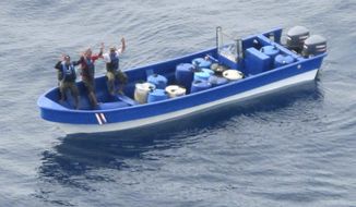 In this photo obtained from U.S. federal court records, Jeffri Dávila-Reyes, third from left, and two others hold their hands in the air as they are intercepted in the Caribbean Sea on Oct. 29, 2015. Dávila-Reyes says he’s still mystified how he ended up serving hard time in a U.S. federal prison. His cocaine bust at sea was closer to his homeland of Costa Rica than the United States, and the few kilos of drugs he was carrying were bound for Jamaica rather than American shores. (U.S. Coast Guard via AP)
