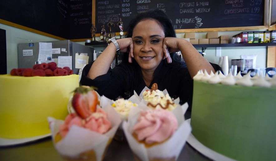 Shirley Hughes, owner of Sweet Cheats bakery, poses for a photo, Friday, April 15, 2022, in Atlanta.  Some small businesses are still struggling to hire qualified workers, even as the broader picture in the U.S. job market looks much brighter.  (AP Photo/Mike Stewart)